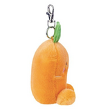 Plush orange keychain with a smiling face on a white background