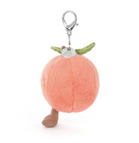 Plush peach-shaped keychain with legs and a tag on a white background