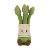 Plush toy of green asparagus with a smiling face on a white background