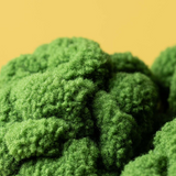 Close-up of green broccoli on a yellow background