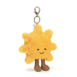 Plush sun-shaped keychain with a smiling face on a white background