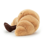 Plush toy shaped like a croissant on a white background