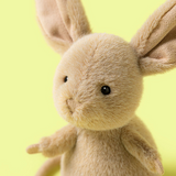 Close-up of a plush rabbit toy with a green background