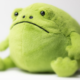 Green plush frog toy on a white background