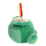 Green plush toy resembling a fish with a red and yellow tail on a white background