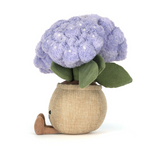 Toy plant with purple flowers and green leaves on a white background