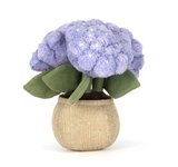 Stuffed toy resembling a purple flower in a beige pot on a white background