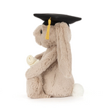 Plush bunny wearing a graduation cap on a white background