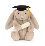 Plush bunny toy wearing a graduation cap and gown on a white background