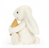 White plush bunny holding a brown heart on a white background