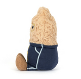 Stuffed toy resembling a banana in a navy outfit on a white background