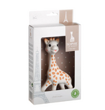 Sophie Le Clouzeau baby teething toy giraffe in its original white and beige packaging, featuring the Eiffel Tower illustrations and a clear window showing the white giraffe with orange spots.