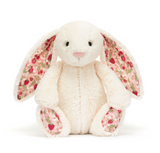 Floral-patterned plush bunny toy on a white background