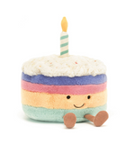 Toy cake with a candle on a white background