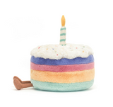 Multicolored plush cake with a candle on a white background