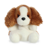 Stuffed dog toy with brown and white fur on a white background