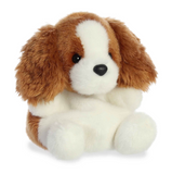 Stuffed dog toy with brown and white fur on a white background
