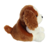 Plush toy dog with brown and white fur on a white background