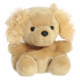 Beige stuffed dog toy with black nose on a white background