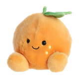 Plush toy resembling a peach with a smiling face on a white background