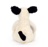 White plush toy with black spots on a white background