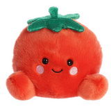Plush toy tomato with a smiling face on a white background