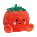 Plush toy tomato with a smiling face on a white background