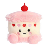 Plush toy resembling a cake with a cherry on top on a white background