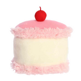 Pink and white fluffy cake-shaped pillow with a red cherry on top on a white background
