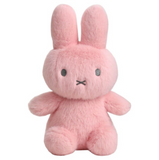 Pink plush toy with a sad expression on a white background