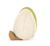 Toy avocado with a green top and beige bottom on a white background
