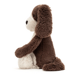 Stuffed animal toy with brown and white fur on a white background
