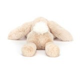 Beige plush bunny toy on a white background