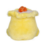 Yellow plush toy resembling a cake with orangeberries on a white background