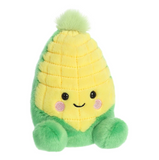 Plush toy resembling a corn on the cob with a smiling face on a white background