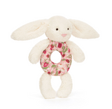 White bunny plush toy with a floral ring on a white background