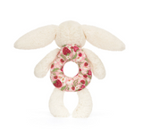White plush bunny toy with a floral ring on a white background