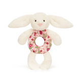 White bunny plush toy with a floral ring on a white background