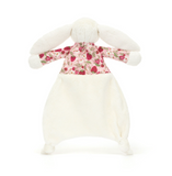 Plush bunny toy wearing a floral sweater on a white background