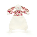 Plush toy rabbit with floral pattern on a white background