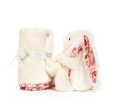 White plush bunny with floral ears and a matching blanket on a white background