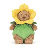 Stuffed toy bear with a yellow flower head and green body on a white background
