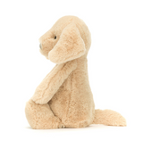 Beige plush toy sitting on a white background