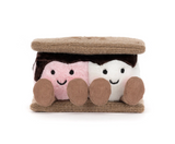 A plush s'mores pillow featuring two smiling faces peeking out from between tan textured buns, with one face in pink and one in white, both with dark brown hair and brown shoes.