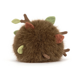 A brown furry plush toy shaped like a round hedgehog or creature, with small green leaves and brown spiky details on a clean white background.