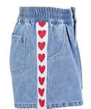 Light blue denim shorts featuring a white vertical stripe down the front side decorated with a repeating pattern of red hearts, set against a plain white background.
