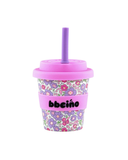 Floral-patterned tumbler with a pink lid and straw on a white background