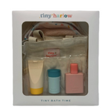 Tiny Harlow bath time set in packaging with a beige pouch, bottle, and containers.