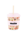 Pink cup with ice cream pattern and straw on a white background