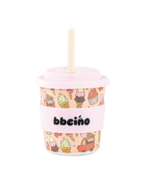 Pink cup with ice cream pattern and straw on a white background